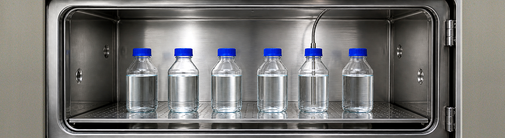 Bottles in an autoclave chamber with a load sensed timing probe in one bottle.