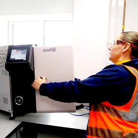 News article image: Sabrina Boulder opening an AMB Benchtop autoclave